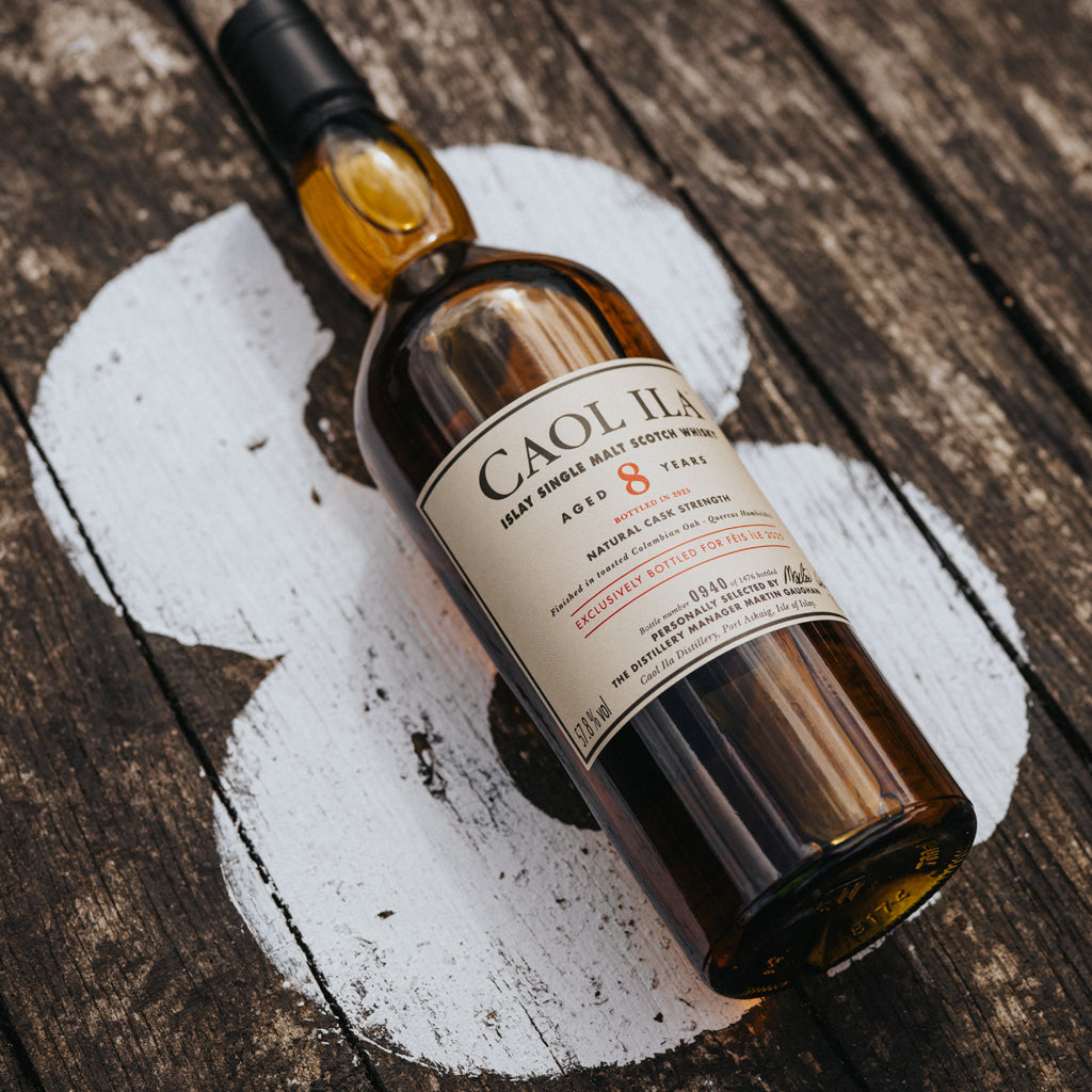 Caol Ila 8 Year Old Islay Malt Whisky bottle laid flat over wooden boards with the number 8 painted in white