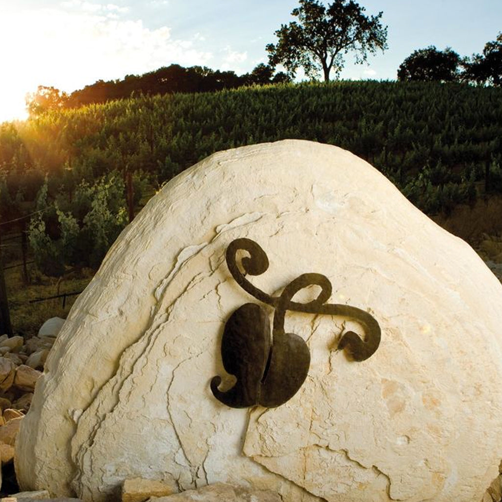 Tablas Creek Vineyard Boulder with Logo In Vineyard