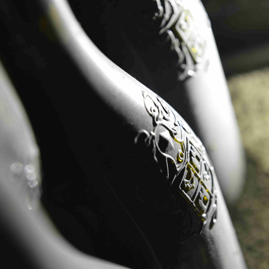 A close up image of Château de Beaucastel's iconic embossed Châteauneuf-du-Pape bottle