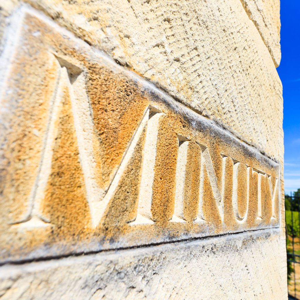 Minuty Marker Stone on side of Building