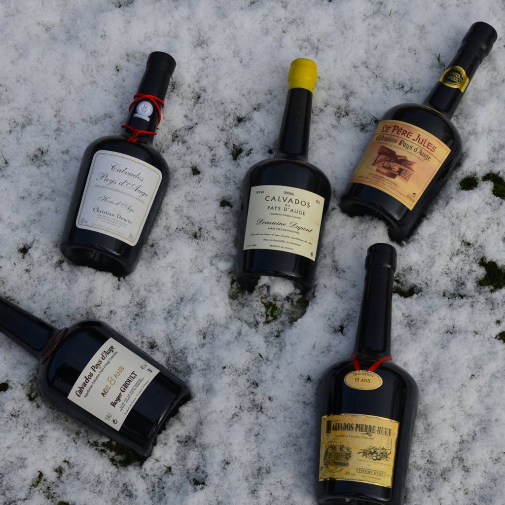 Calvados Bottles laying snow