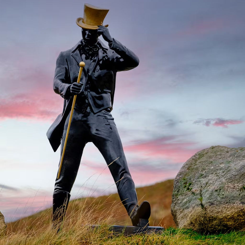 Statue of Johnnie Walker striding the highlands of Scotland 