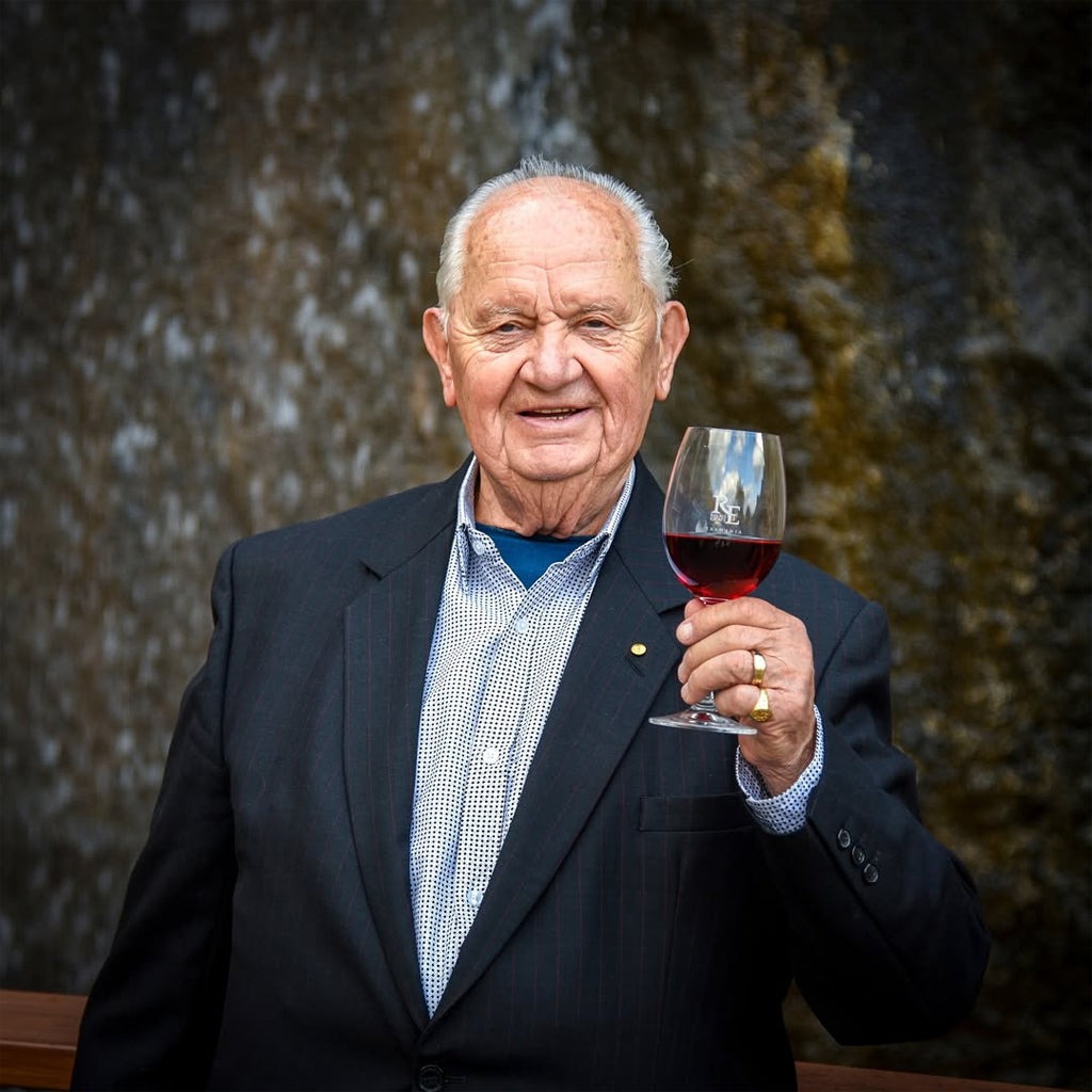 Picture of Josef Chromy holding a glass of red wine