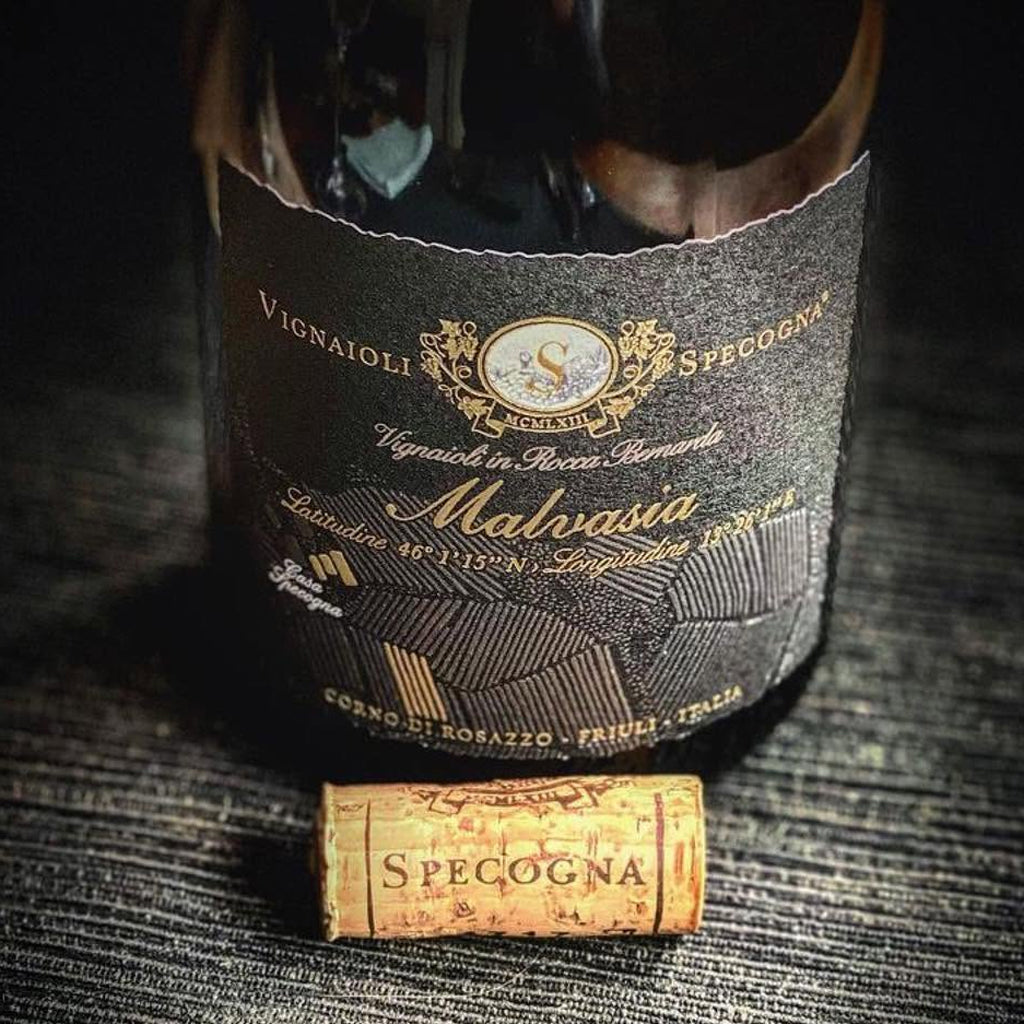 Close up photo of a bottle of Specogna Malvasia and Cork with the word Specogna stamped on its side