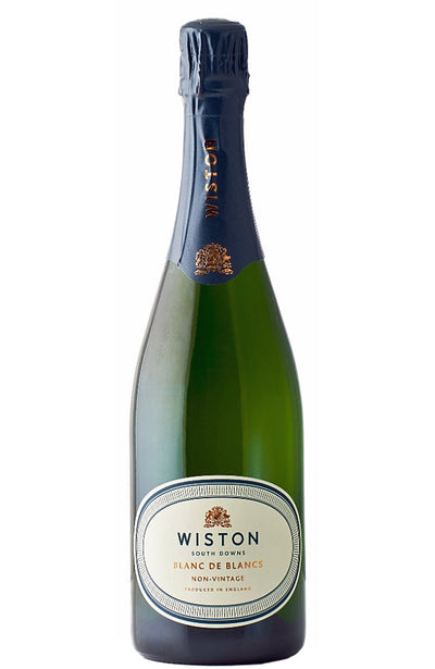 A bottle of Wiston Estate Blanc de Blancs sparkling wine, featuring a dark green glass bottle, dark blue foil, and a white oval label.