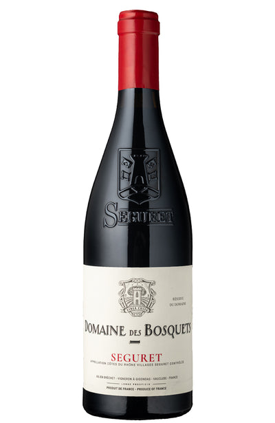 A bottle of Domaine des Bosquets Seguret red wine, featuring a dark glass bottle with a cream-colored label and a red foil capsule at the top, isolated on a white background.