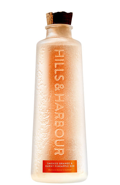 A frosted glass bottle of Hills & Harbour Smoked Orange & Burnt Pineapple Gin, featuring a cork stopper and an orange label at the bottom, set against a plain white background.
