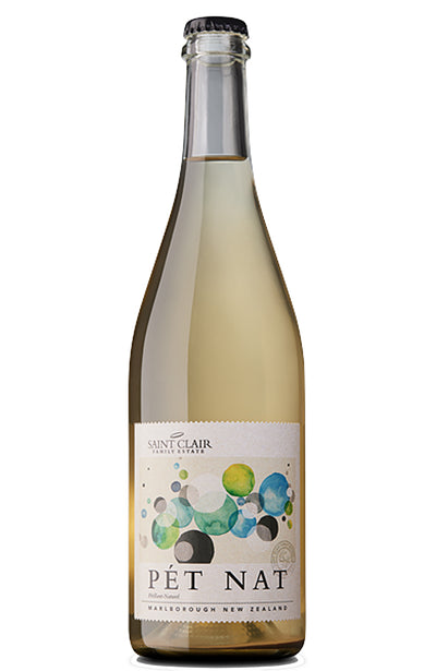 A bottle of Saint Clair Pet Nat New Zealand white wine, featuring a pale golden-amber liquid inside a clear glass bottle with a cream-colored label decorated with colorful watercolor circles.
